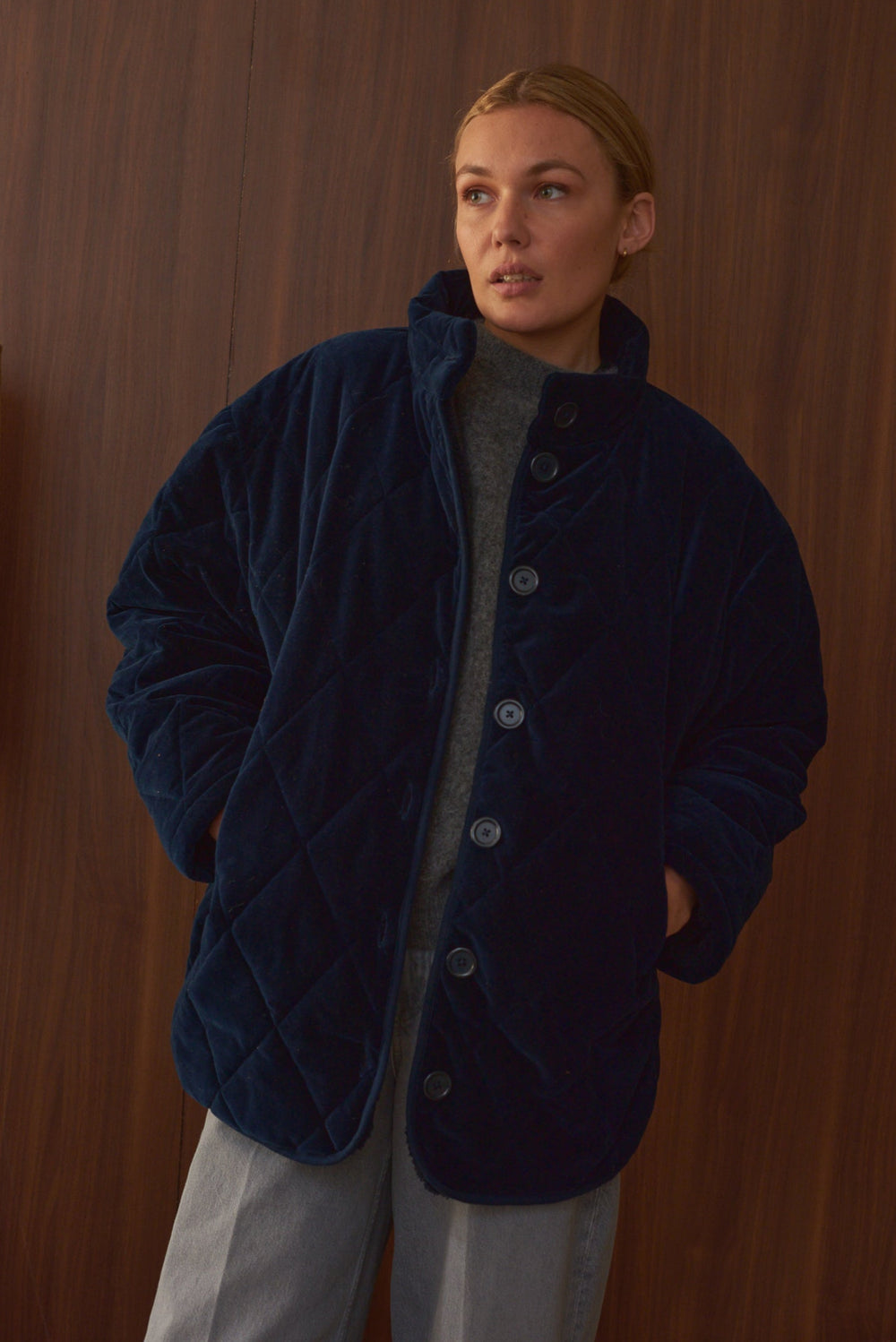 Portrait femme portant manteau velours matelassé bleu indigo Marlot Paris. 